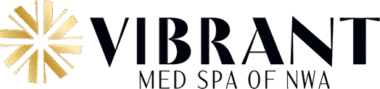 Logo for Vibrant Med Spa of NWA, featuring the word VIBRANT in bold, black letters beside a stylized gold starburst design.